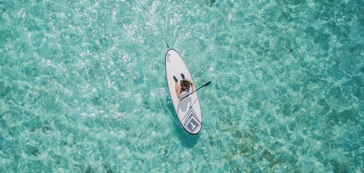 Aerial photo of someone on a paddleboard.